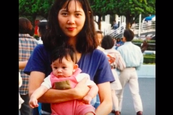 Natasha's mom carrying her when she was a baby