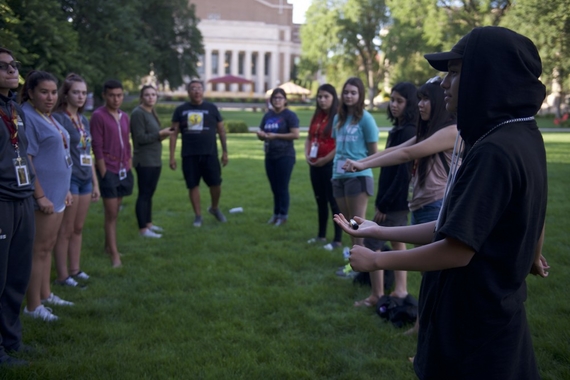 High schoolers playing a Lakota version of a handgame outside of Northrop