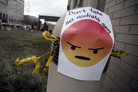 A sign with an angry emoji reads "Don't take net neutrality away" is posted outside the Federal Communications Commission (FCC), in Washington, Thursday, Dec. 14, 2017