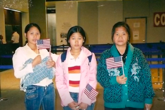Pa, her mother, and her sister holding American flags