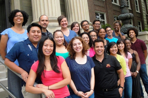 Photo of group of grad students at a diversity institute, standing on the steps outside of a building.