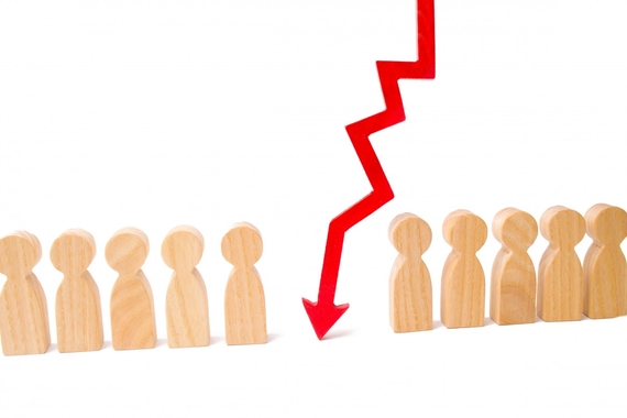 a line of small wooden figures shaped like people with a red cartoon arrow showing a steep decline