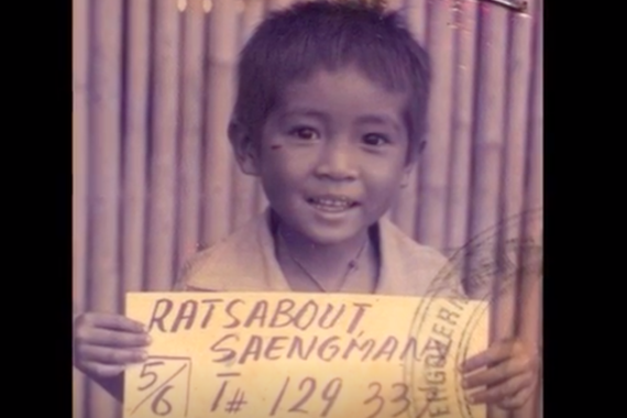 Photo of Saeng when he was a small boy holding a sign
