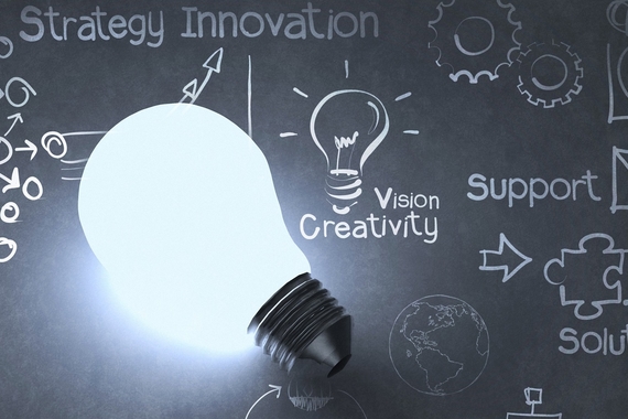 A light bulb sits atop the words "strategy, innovation, vision, creativity, support, solution" and images of arrows and gears
