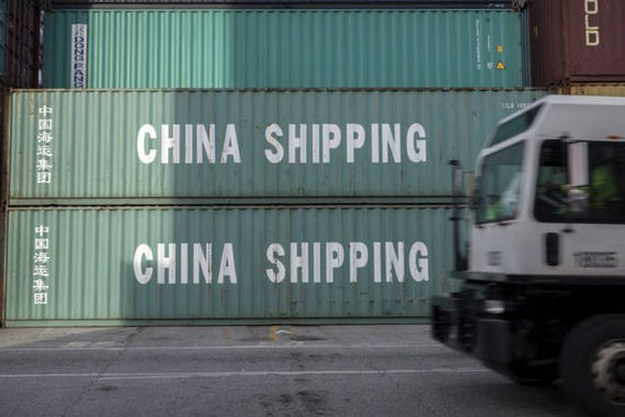 Stacks of large shipping containers that say "CHINA SHIPPING"