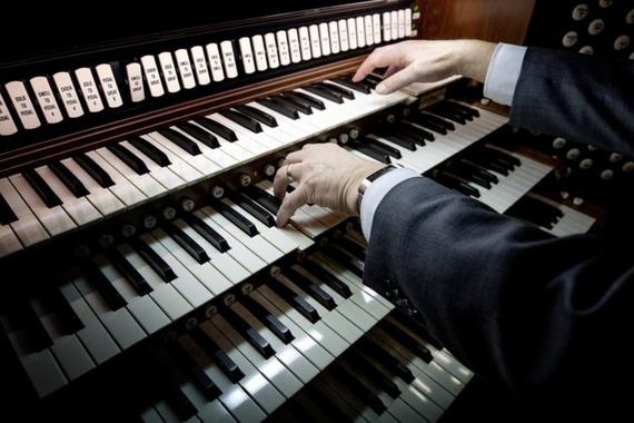 A pair of hands playing the new pipe organ at Northrop auditorium