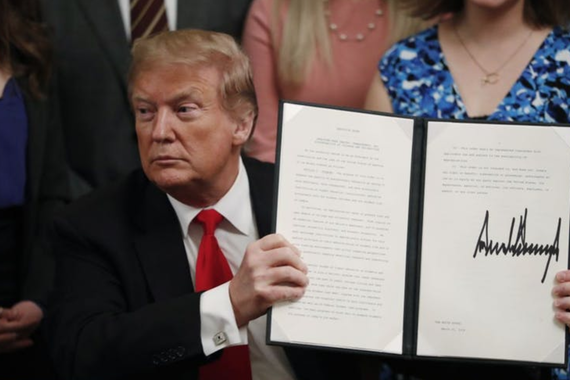 President Donald Trump held up an executive order he signed Thursday requiring colleges to certify that their policies support free speech as a condition of receiving federal research grants.