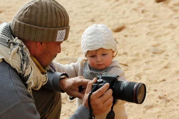 Archaeologist John Ward shows his daughter how to operate a camera in the field in Egypt.