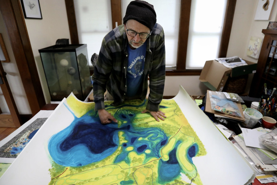 Sean Connaughty, considered by many to be Lake Hiawatha’s personal caretaker, studied his painting of the lake and surrounding area, including the nearby Hiawatha Golf Course.