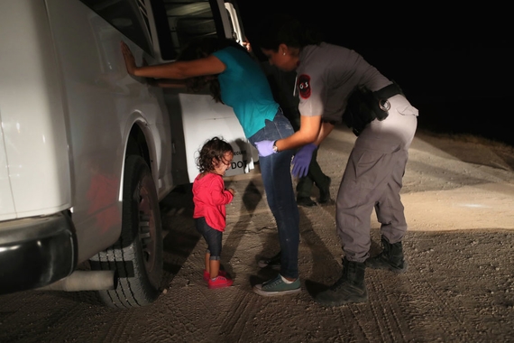 A two-year-old Honduran asylum seeker cries as her mother is searched and detained near the U.S.-Mexico border on June 12, 2018 in McAllen, Texas.