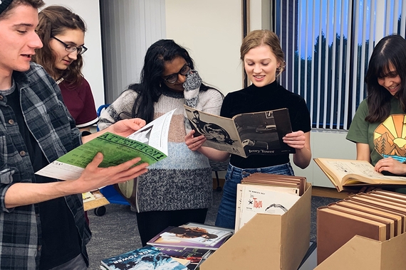 Undergraduate students looking at Tower literary magazine archives