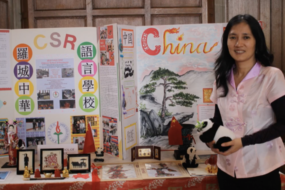 Shirley standing in front of a board she made about her Chinese heritage.