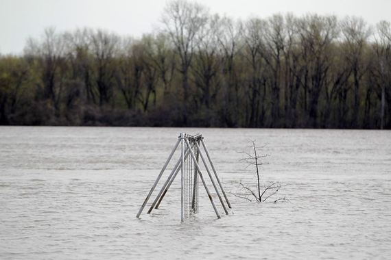 A swing set sits submerged in floodwater from the Mississippi River, April 21, 2013, in Clarksville, Mo.