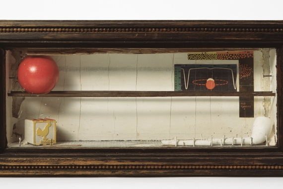 Photo of work of art by Joseph Cornel showing object inside a wooden box with a glass top.