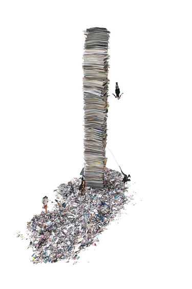 Image of a tower of paper with people and trash at the bottom