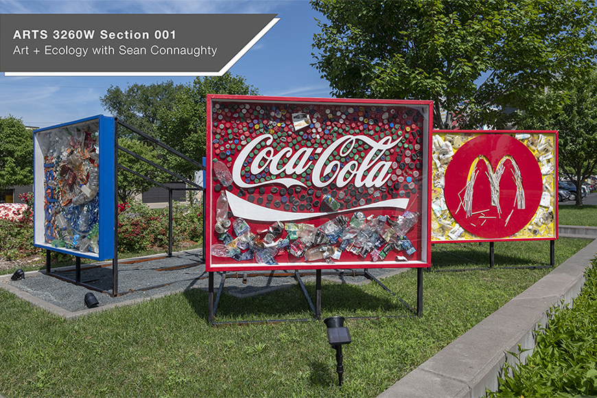 Signboards made from trash that is branded Coca-Cola, McDonald’s, and Pepsi.