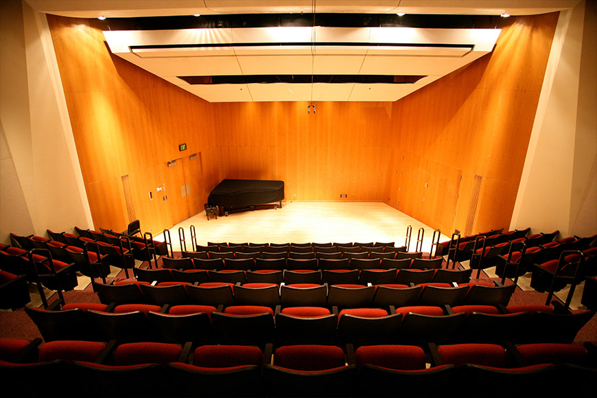 Stage in Ferguson Hall showing seating and grand piano on stage