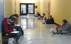 Students sitting on floor of hallway in Lind