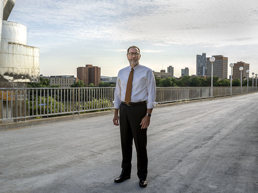 The Dean of CLA stands on the Washington avenue bridge.