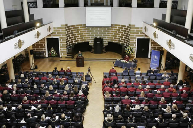 Kirtley speaking in a large hall