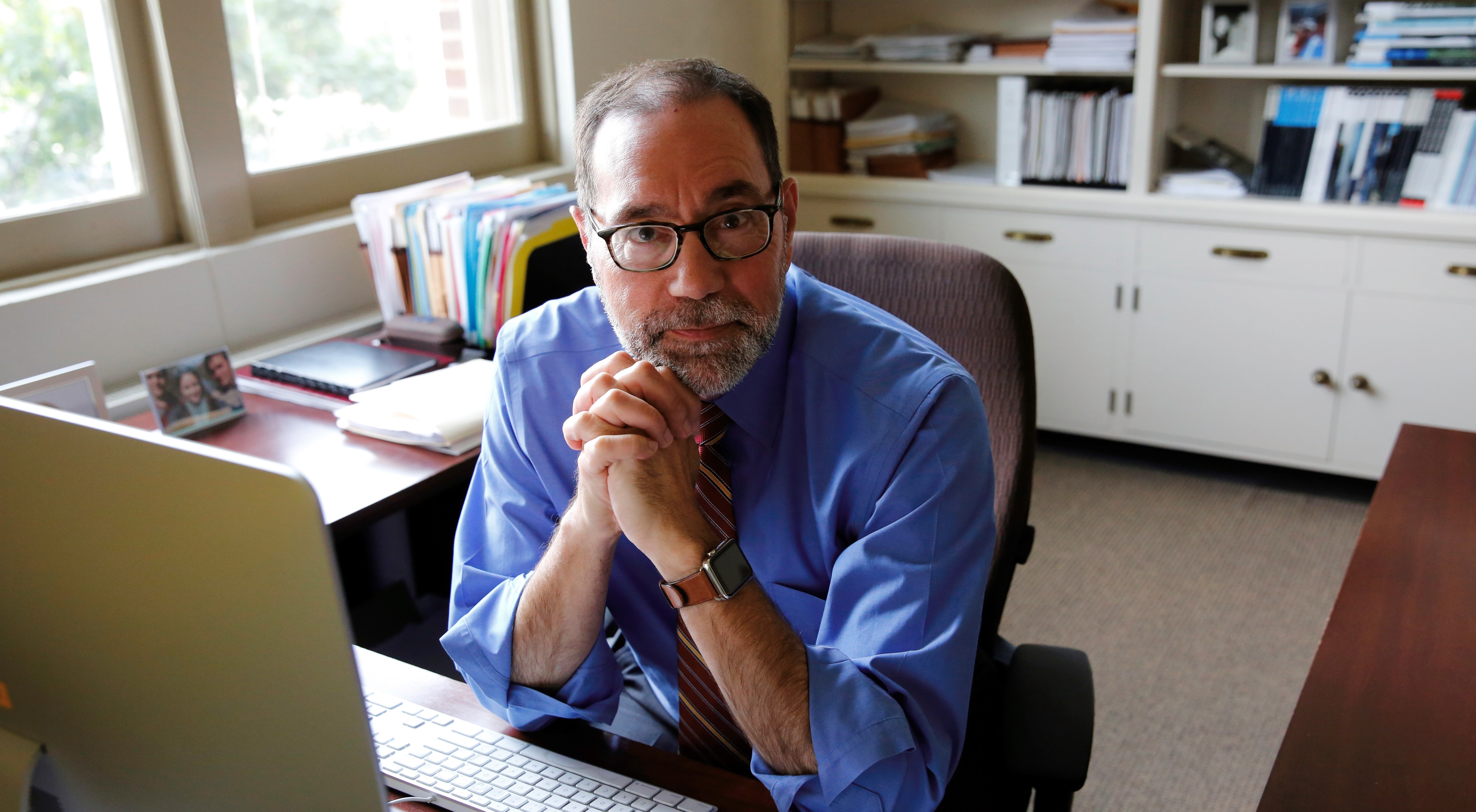 John Coleman, dean of the College of Liberal Arts, sitting at a desk in an office