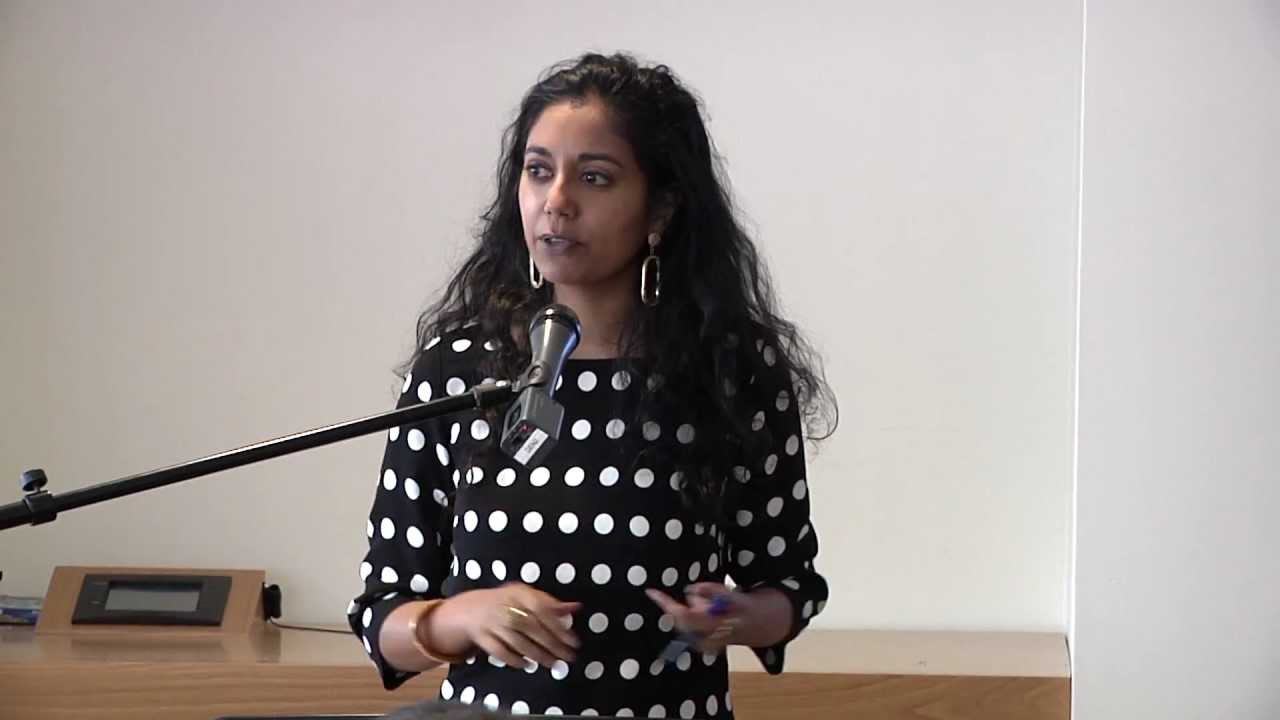 Mayanthi Fenando Speaking into a microphone
