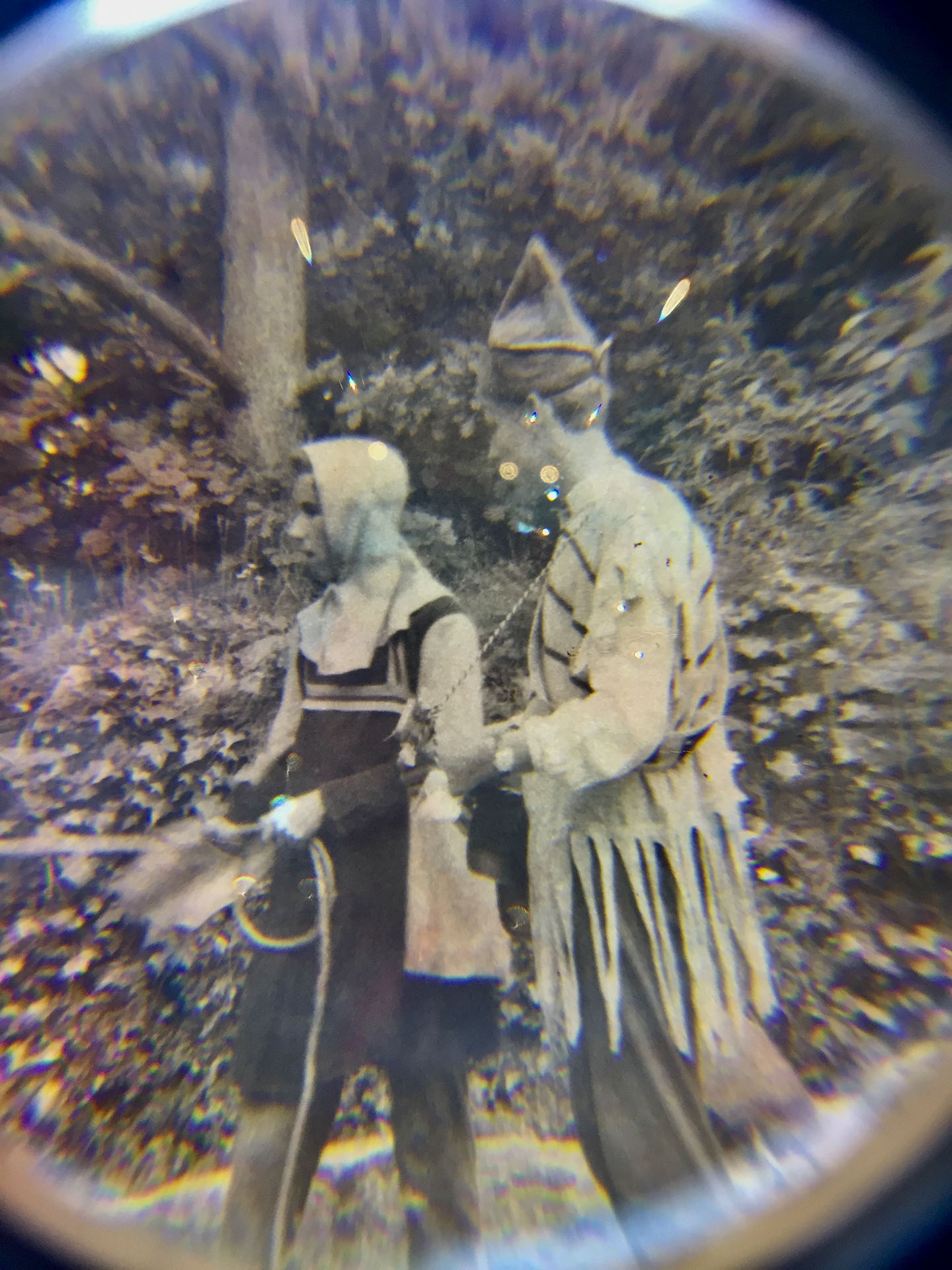  magnified image with glitter of an old photograph of 2 young people in a forest