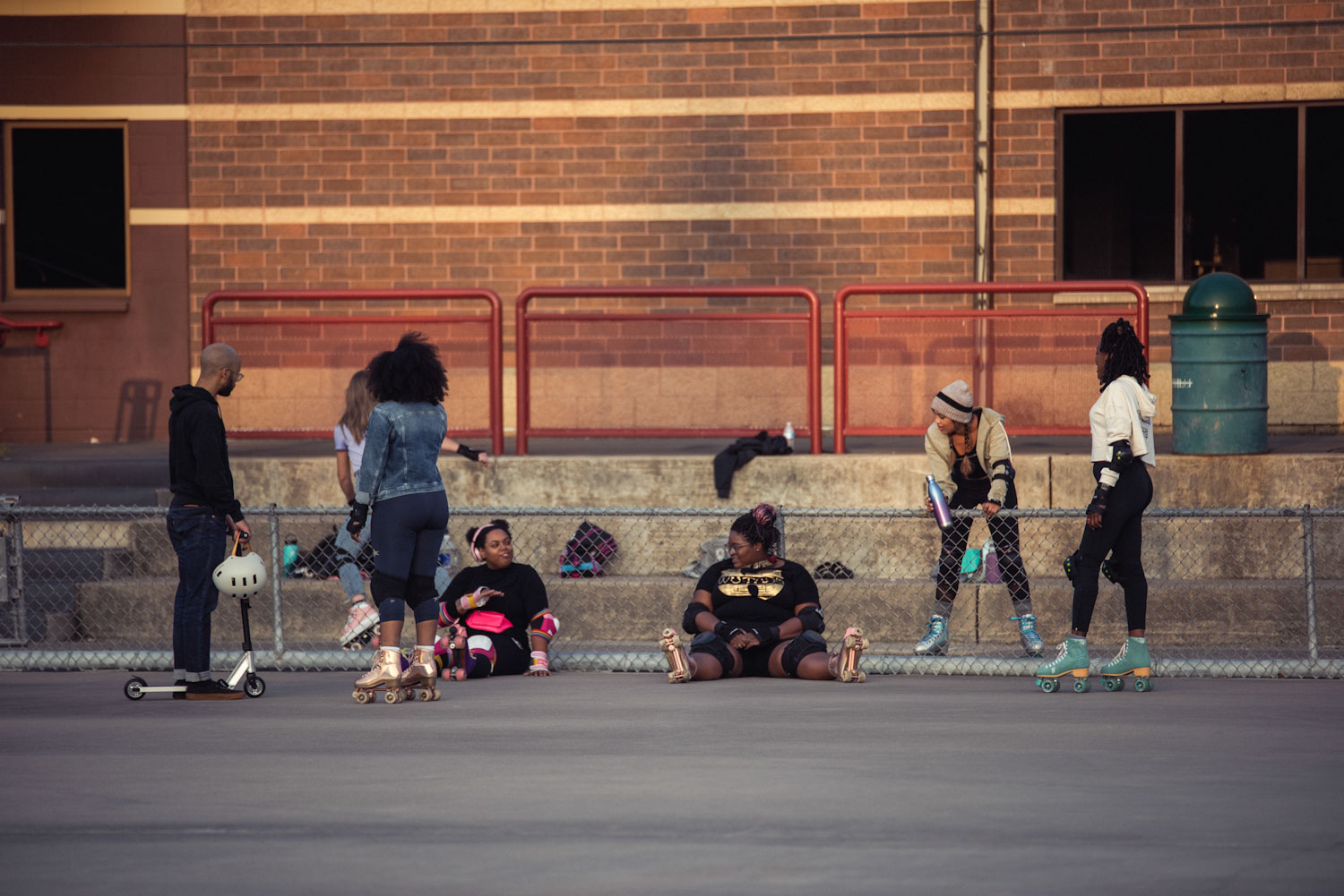 Group of roller-skaters relaxing on a playground 