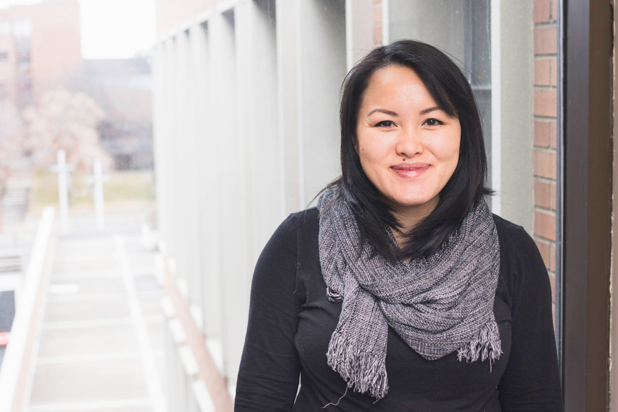 Portrait of graduate student Mai See Thao outside the Social Sciences Building on the University of Minnesota West Bank campus