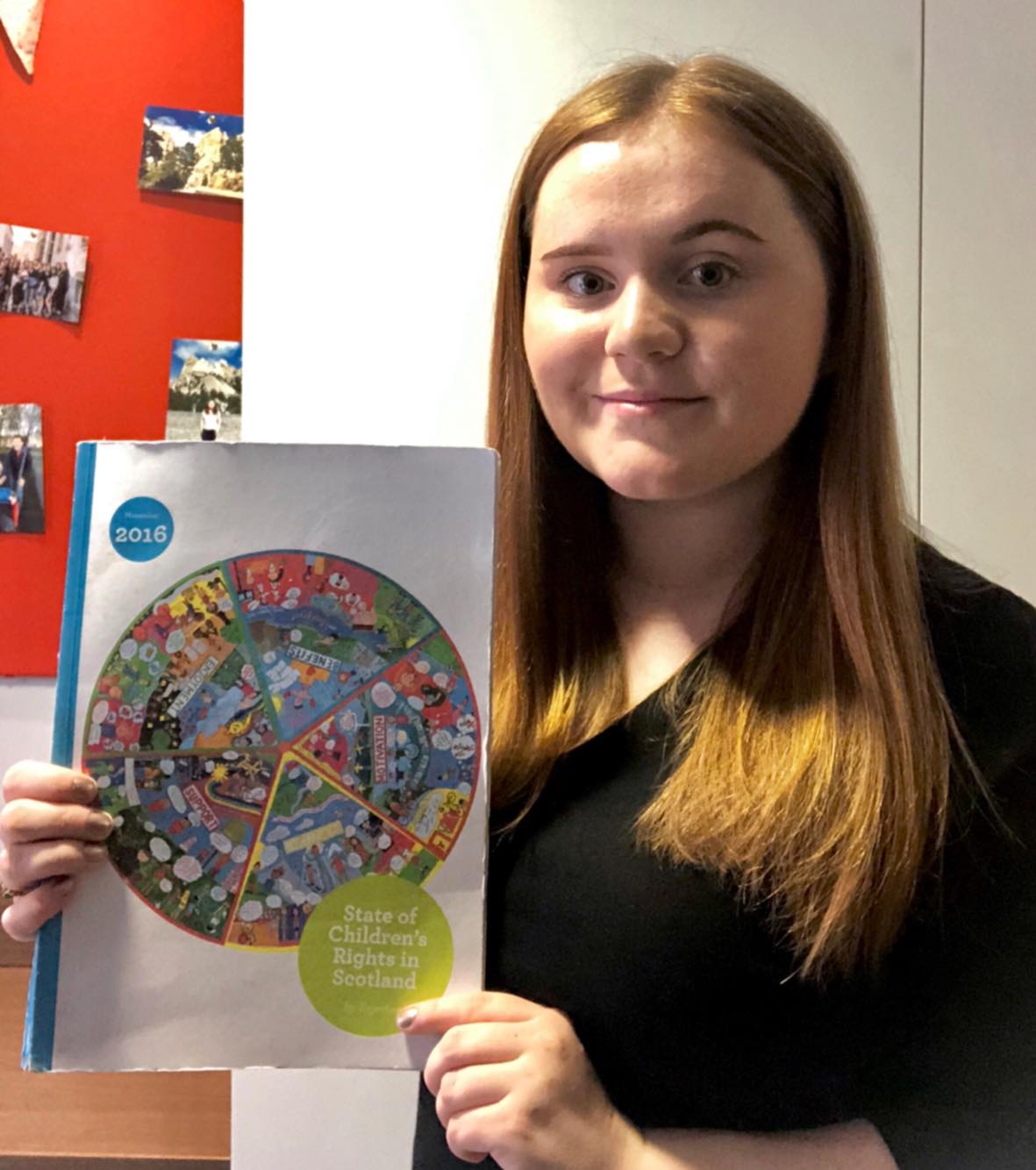 Katie with a copy of the 2016 State of Children’s Rights Report
