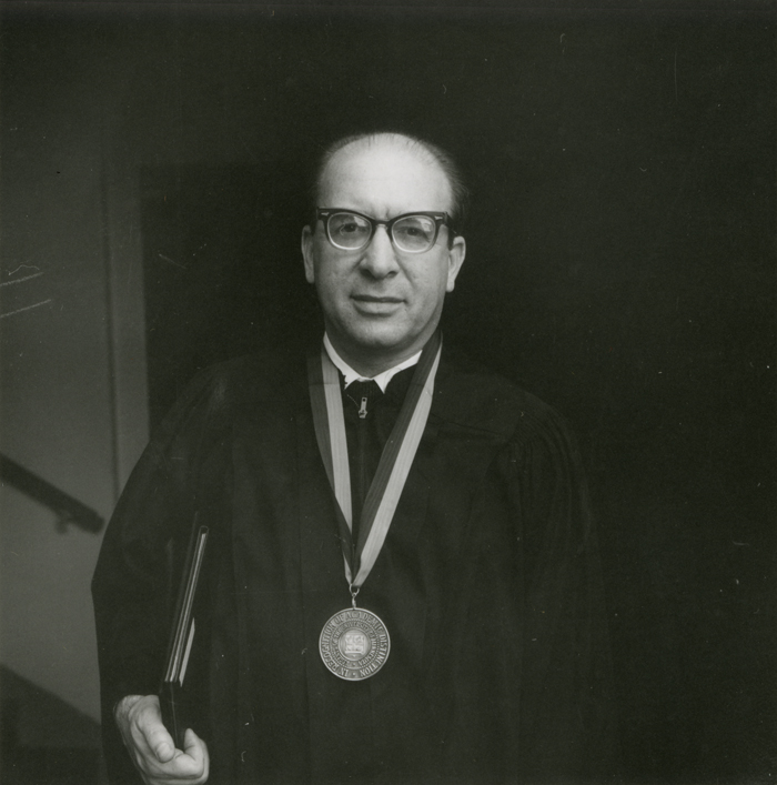 Black and white photo of Leo Hurwicz wearing a medal on a ribbon around his neck