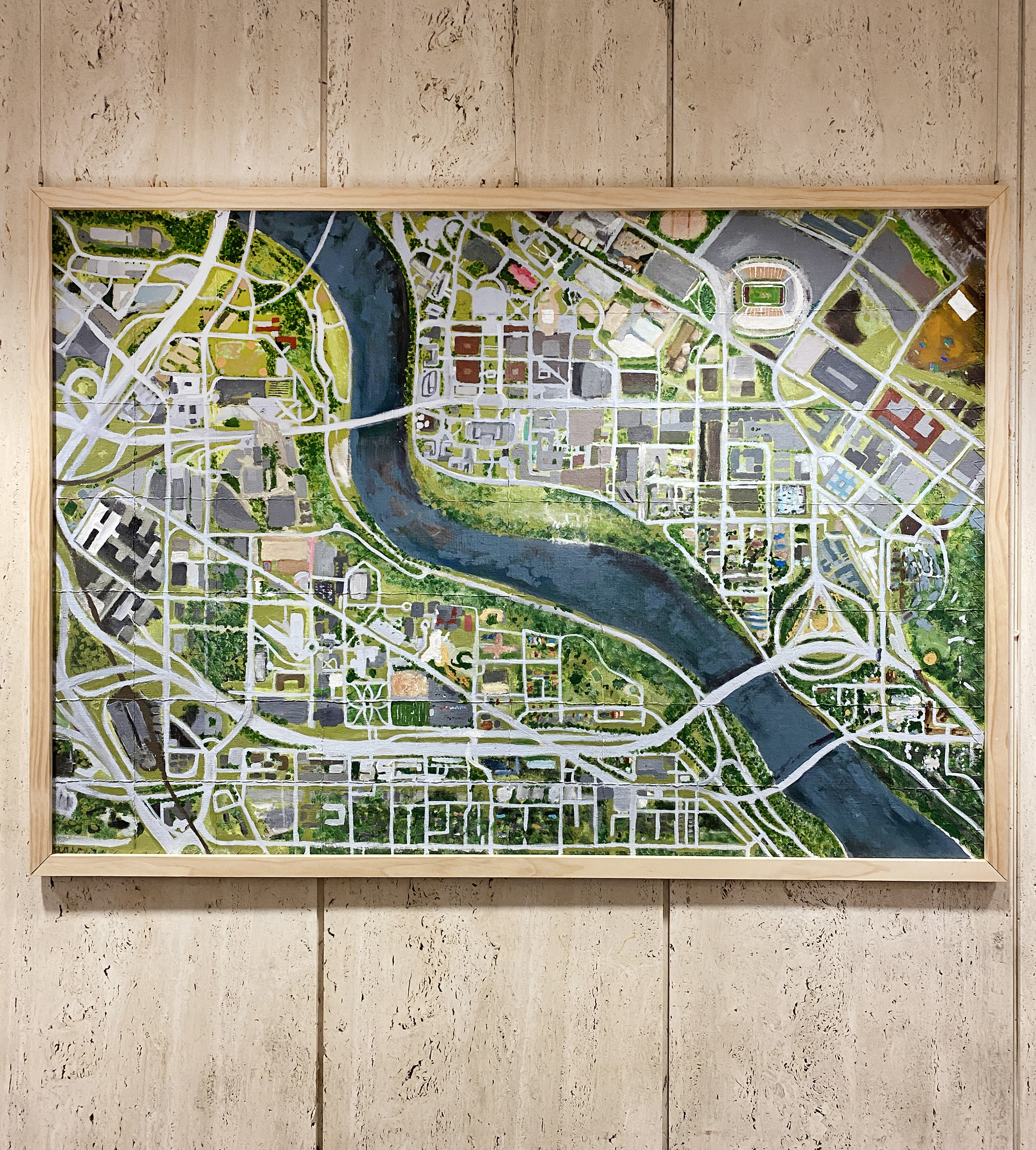 Framed painted map of the East and West Bank campuses with the Mississippi River winding through the middle